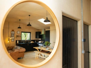 Wall mounted mirror with the reflection of the kitchen, living and dining area