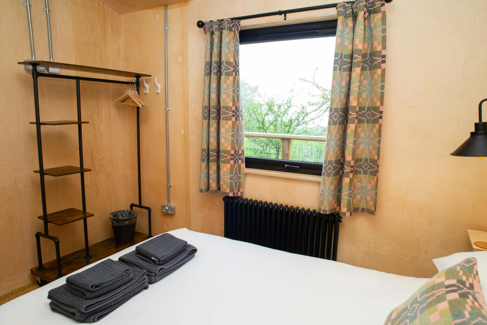 King size bedroom with clothes hanging rail and shelves