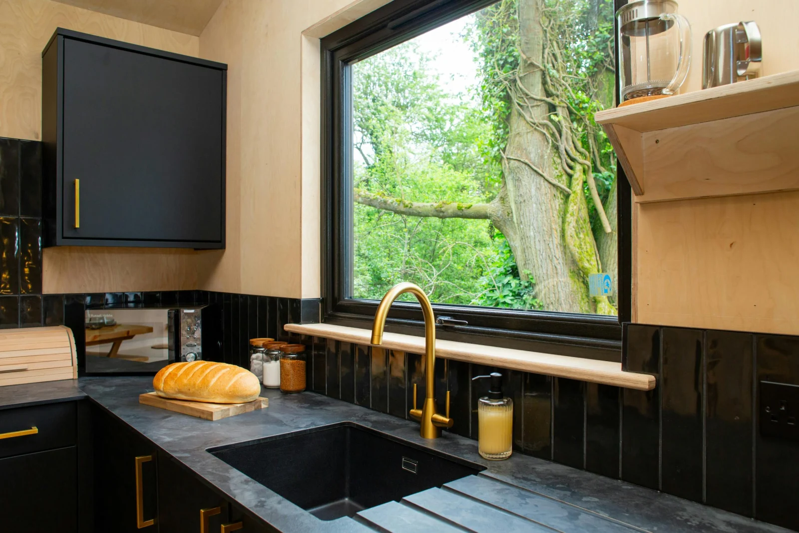 Kitchen with black marble effect work tops