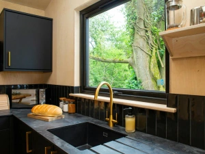 Kitchen with black marble effect work tops