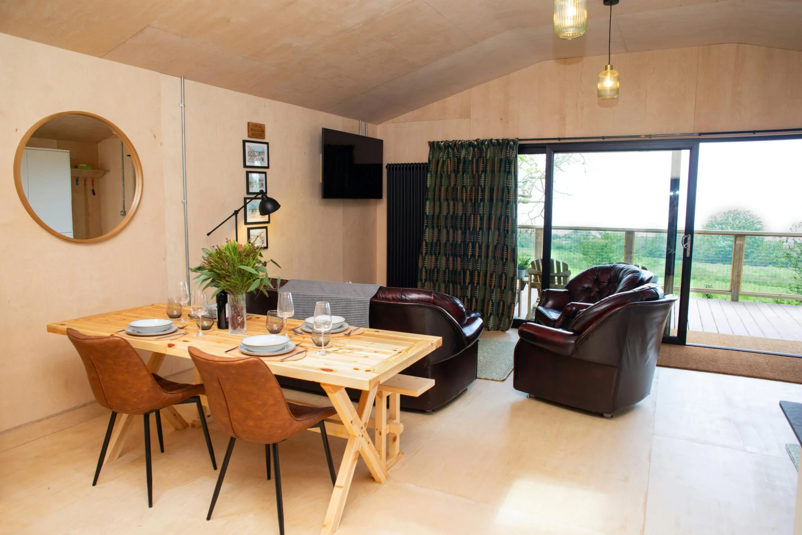 Dining area with table, chairs and bench. Patio doors leading to the veranda