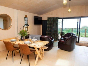 Dining area with table, chairs and bench. Patio doors leading to the veranda