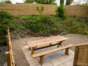 Patio area with wooden table and benches