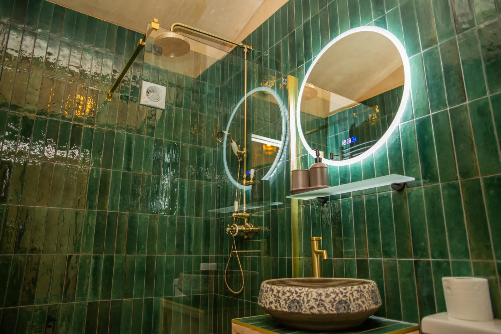Wash hand basin and brass mixer tap. Wall mounted mirror with light
