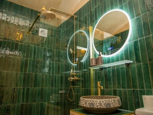 Wash hand basin and brass mixer tap. Wall mounted mirror with light