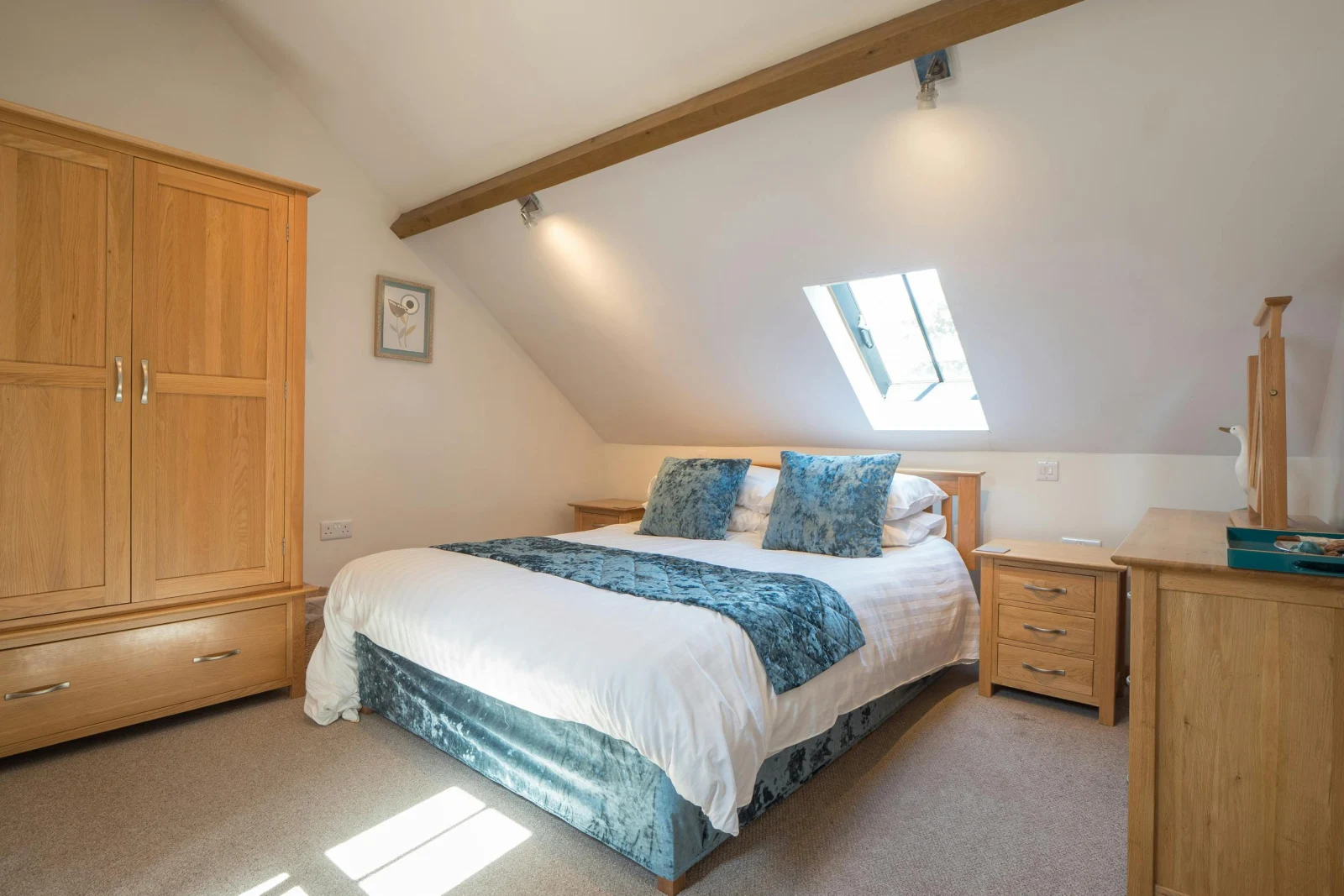 King size bed, oak wardrobe, bedside drawers, chest of drawers and mirror; velux window