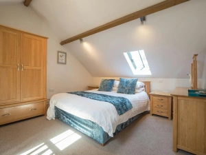 King size bed, oak wardrobe, bedside drawers, chest of drawers and mirror; velux window