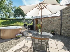 Private patio at Briallen with hot tub, table and chairs