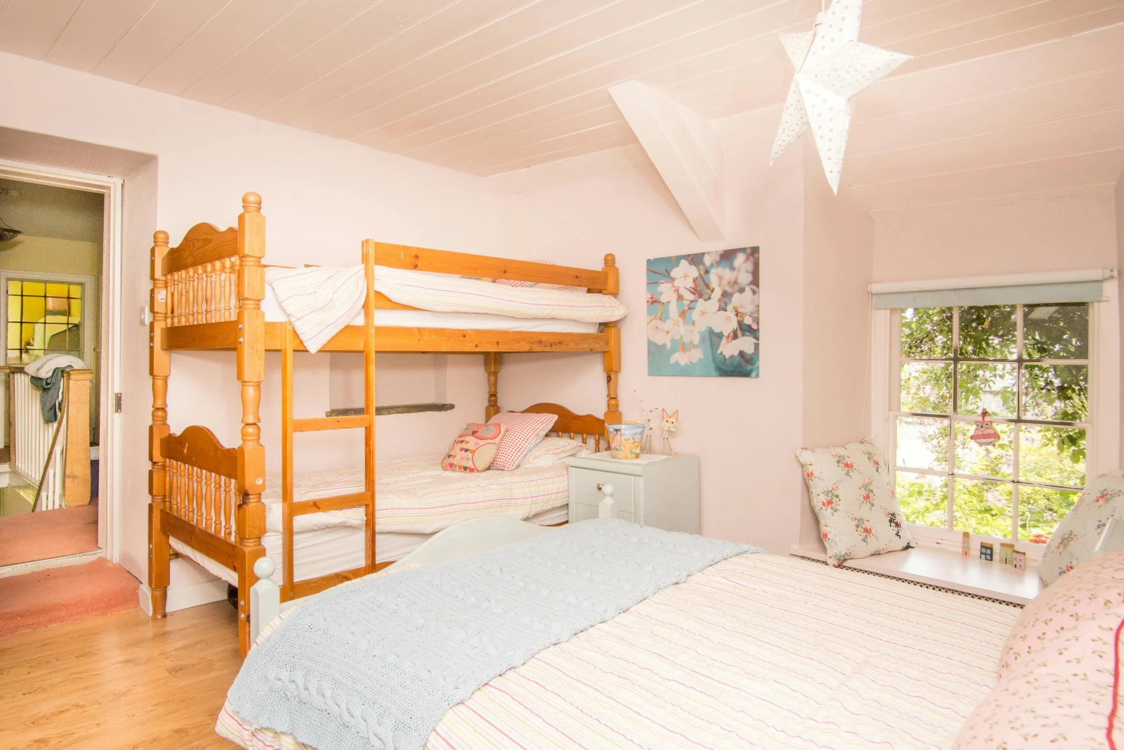 Family bedroom with double bed & bunk beds and bedside cabinet