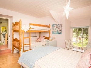 Family bedroom with double bed & bunk beds and bedside cabinet