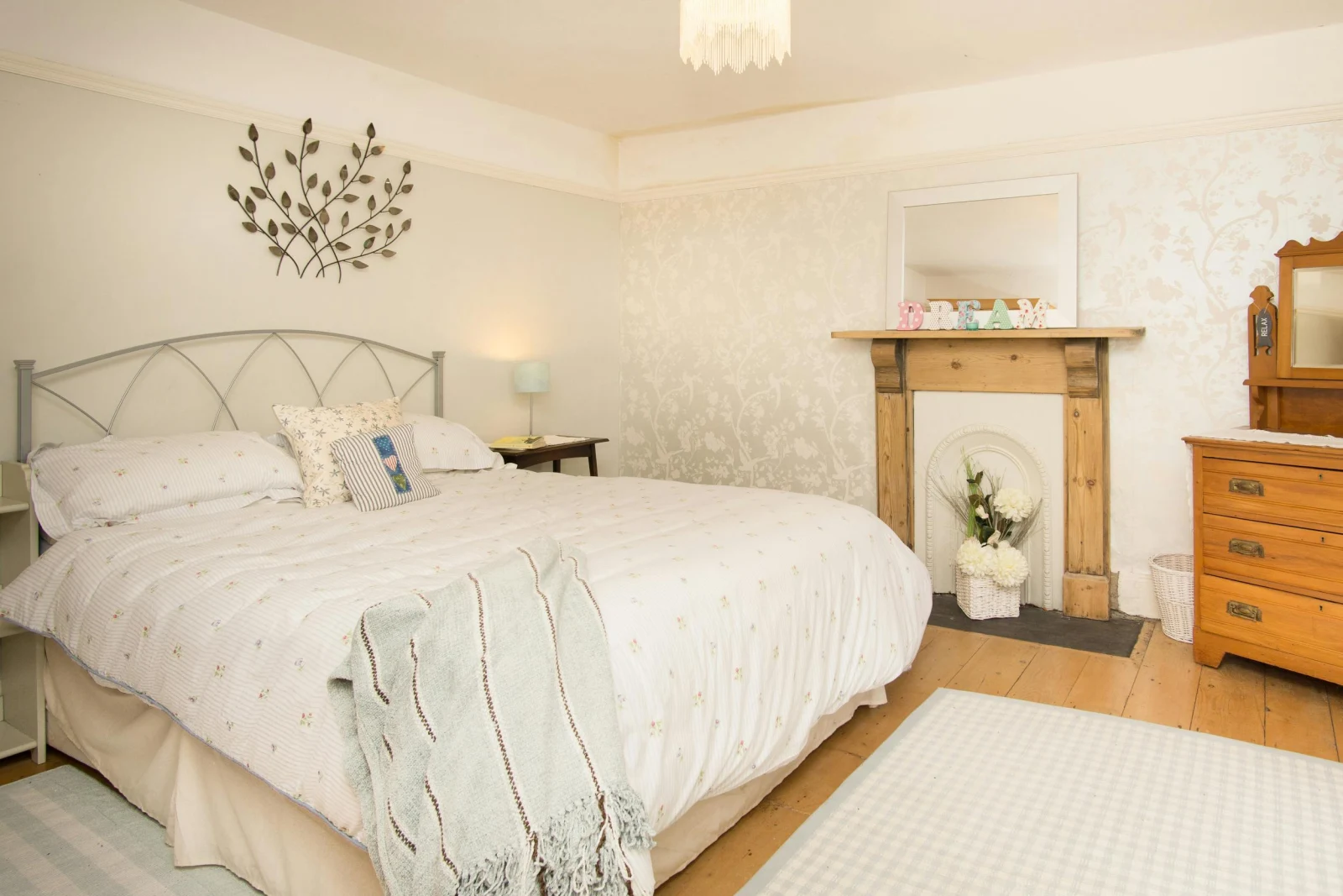 King size bed, bedside table with lamp, chest of drawers and mirror