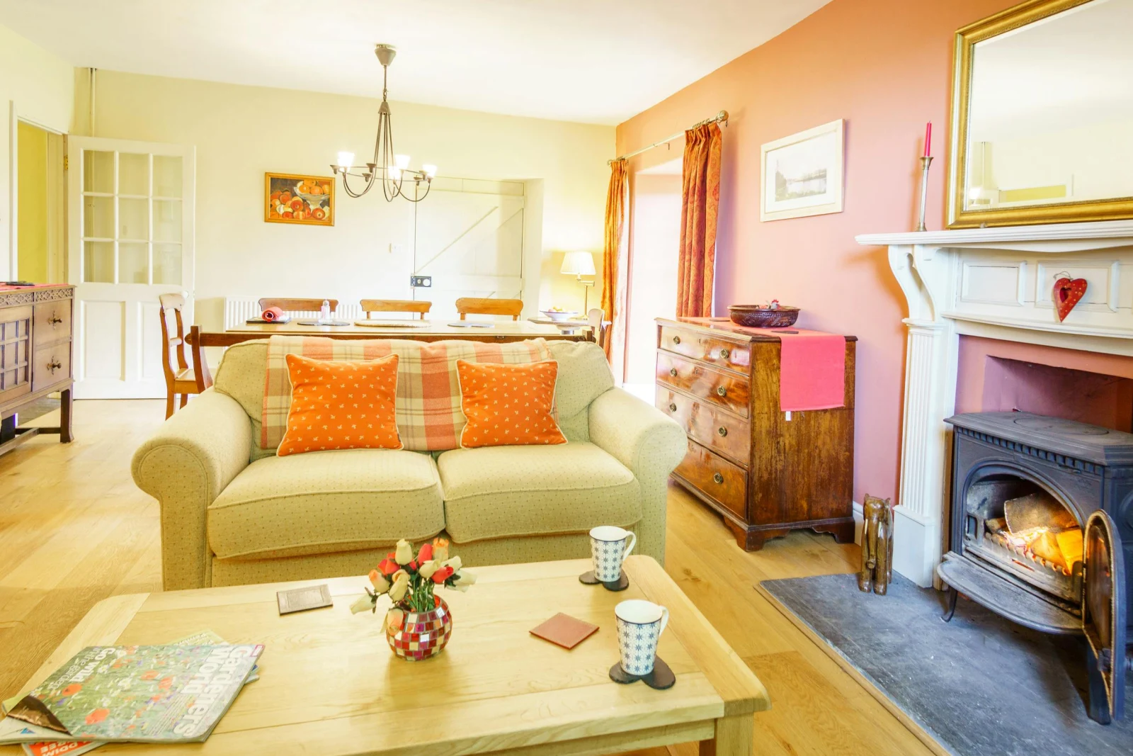 Large dining/sitting room with sofas, dining table and chairs and log burner