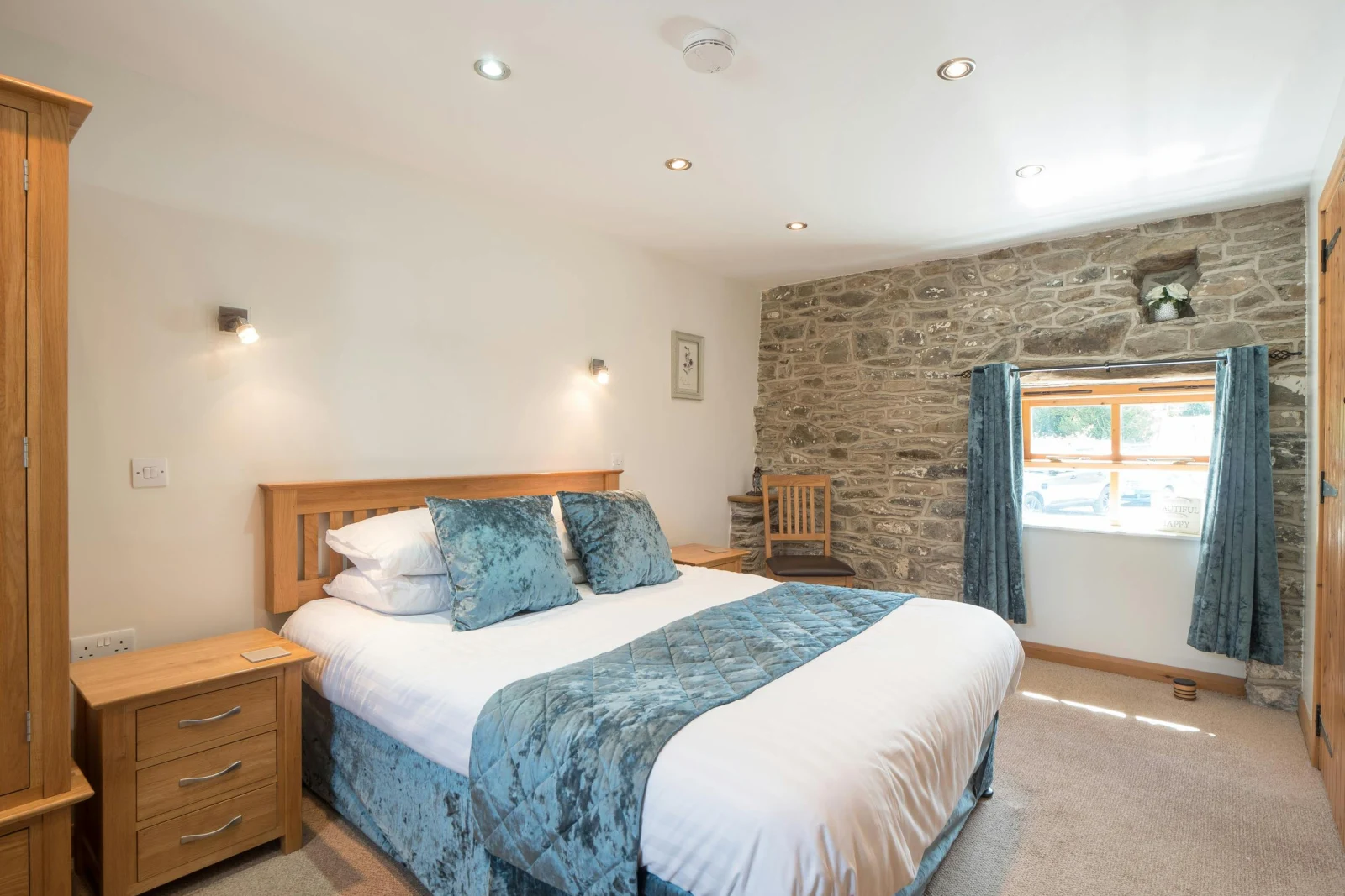 King size bed, bedside cabinets, wardrobe, chair and window