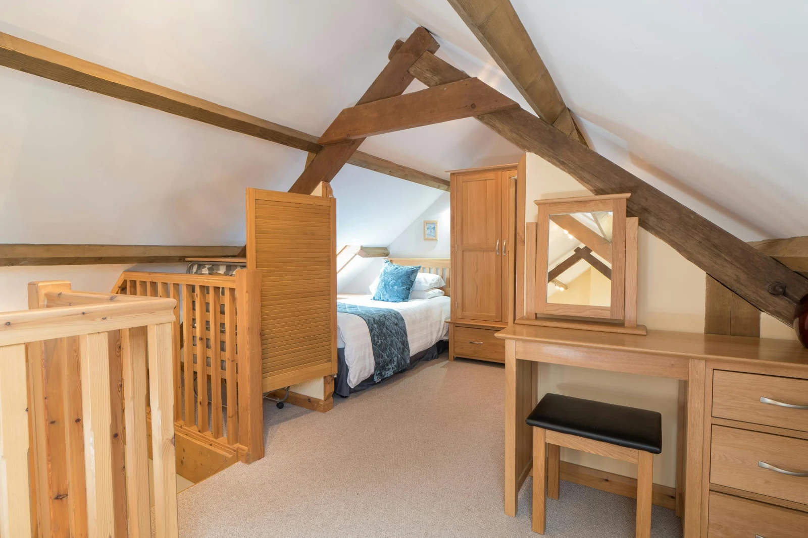 Mezzanine at Eirlys with twin bed, dressing table and stool