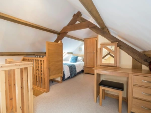Mezzanine at Eirlys with twin bed, dressing table and stool