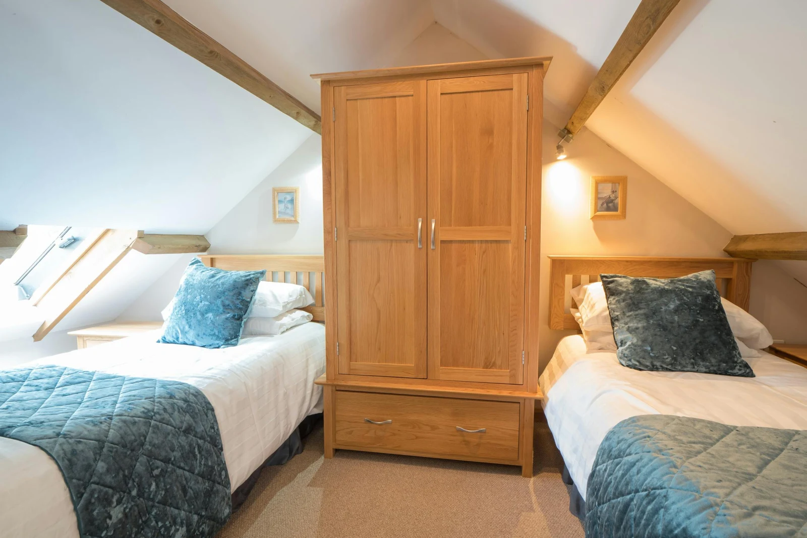 Twin single beds in the eaves at Eirlys, beds, wardrobe and velux window.