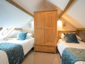 Twin single beds in the eaves at Eirlys, beds, wardrobe and velux window.